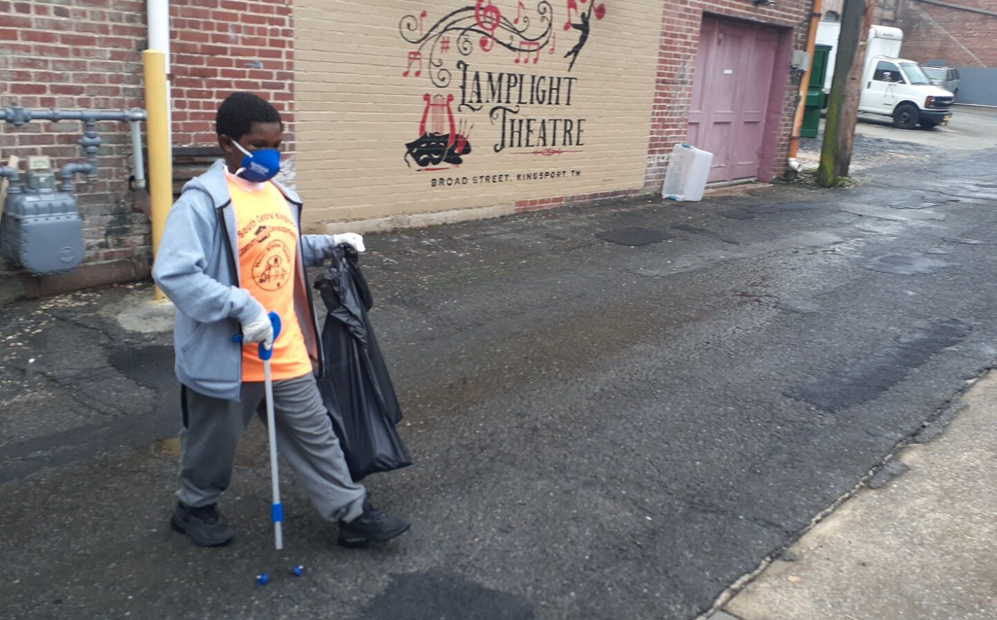 New Vision volunteers help with downtown cleanup